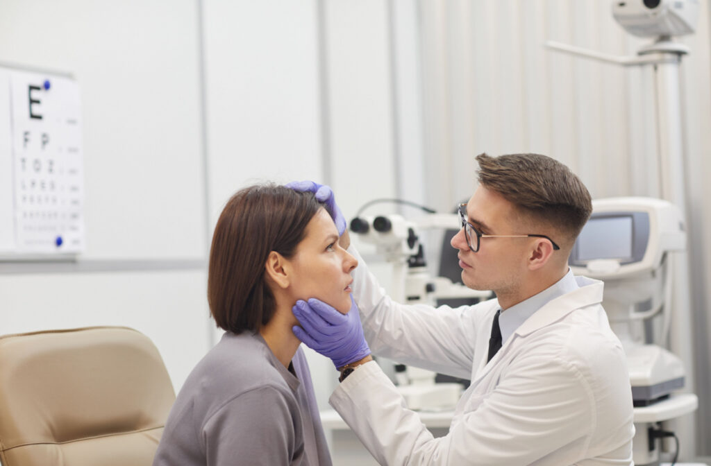 An optometrist examining a patient's eye for a stuck contact lens.