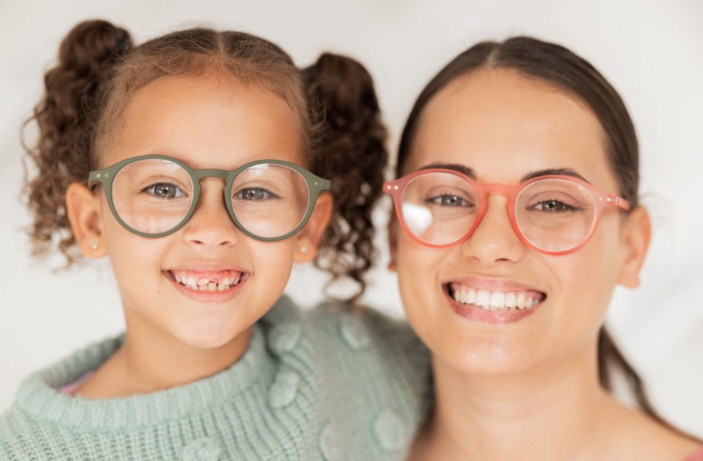 A young girl and a young woman are wearing glasses, which are provided by their health insurance.