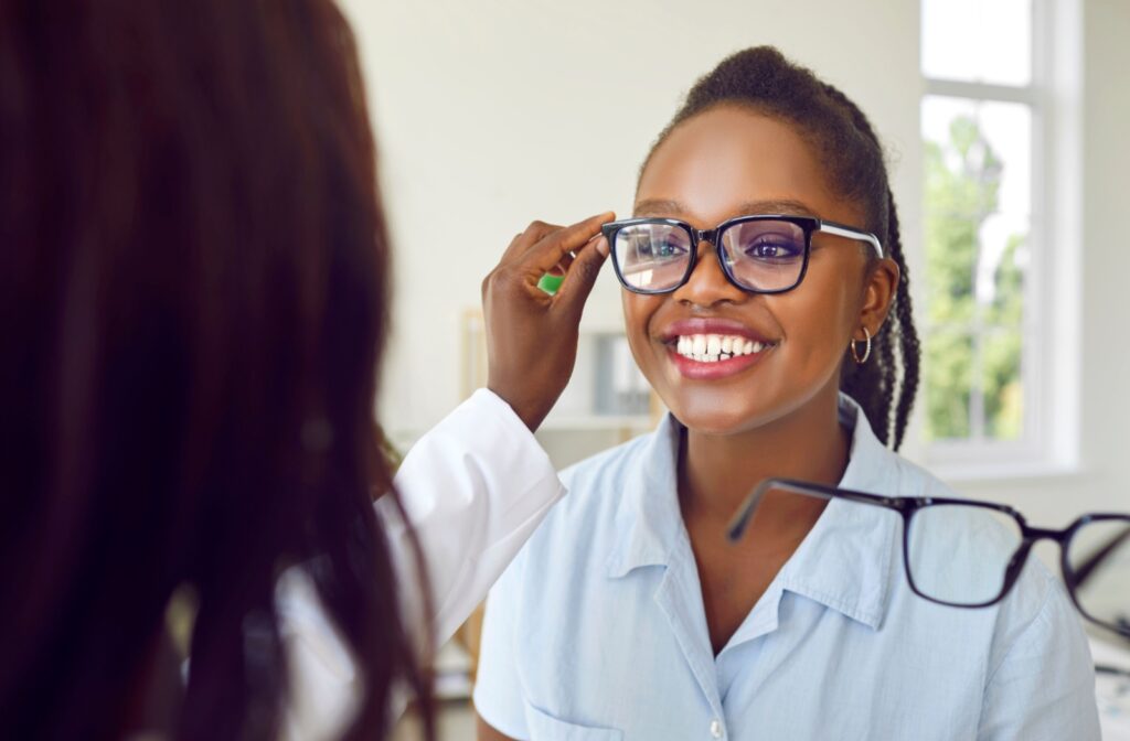An optician helps their patient choose frames that complement their face shape.
